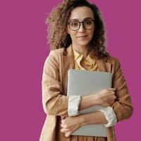 Woman holding a laptop to her chest