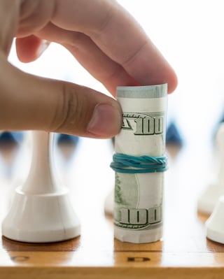 Playing chess with money